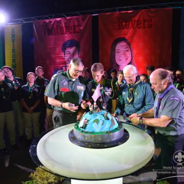 The cutting of the cake by Mr Wayne Perry, SAM recipient, His Majesty and João Gonçalves (Chairman WSC)